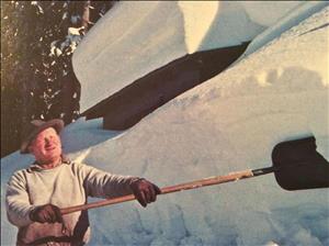 A white man shoveling snow